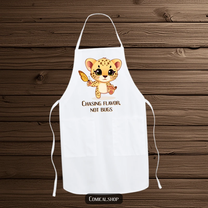 Funny cheetah cub playfully chasing a butterfly with wide eyes, a humorous and practical apron for playful cooks.