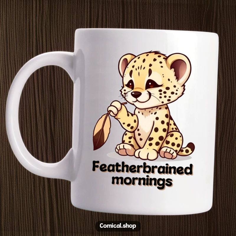 Funny cheetah cub mug featuring a playful cub batting at a dangling feather with intense focus.