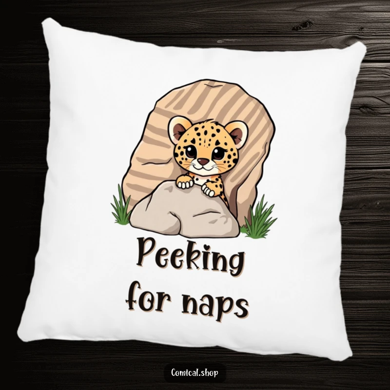 Funny cheetah cub peeking from behind a rock on a plush pillow, depicting playful surprise for screen reader users.