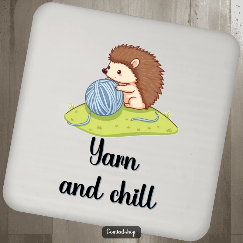 Funny drink coaster featuring a small hedgehog rolling a large ball of yarn, perfect for protecting surfaces with charm.