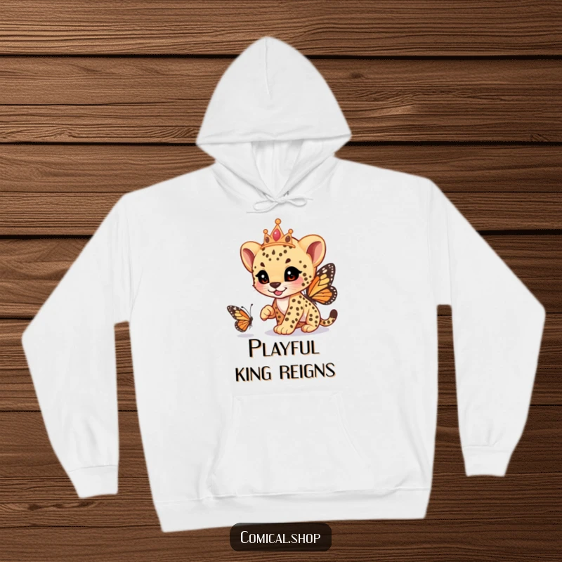 Funny cheetah cub wearing a tiara, playfully racing a butterfly, on a warm hoodie, designed for fun, a hilarious funny gift.
