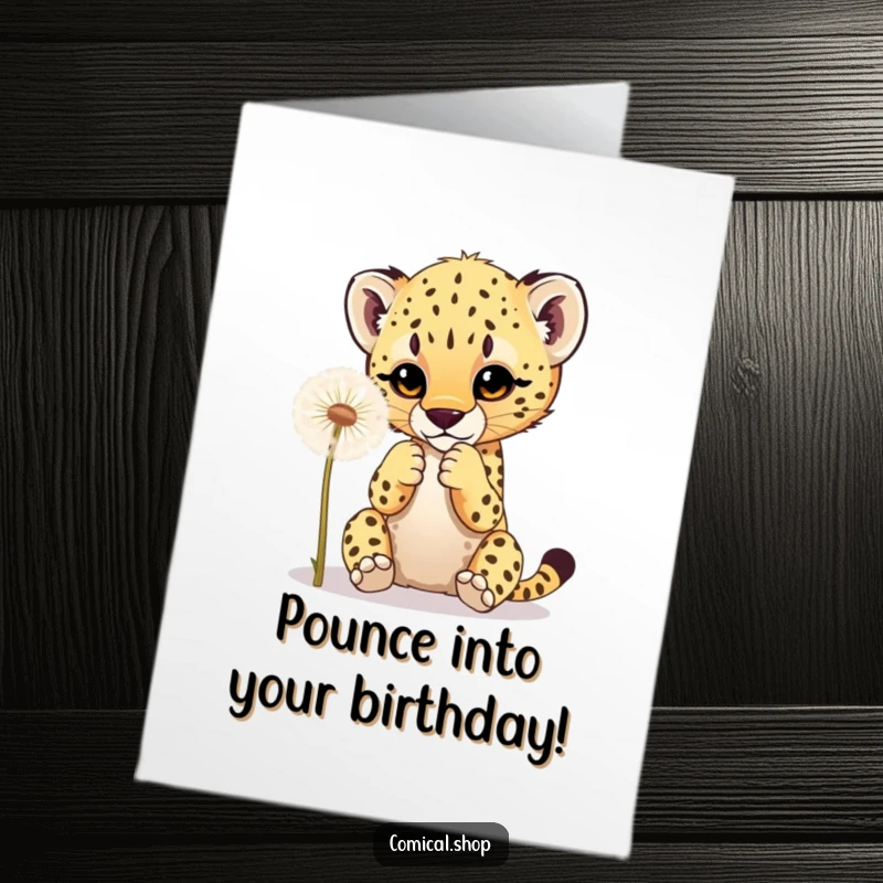 Funny free printable birthday card showing a cute cheetah cub playfully batting at a fluffy dandelion with its tiny paws.