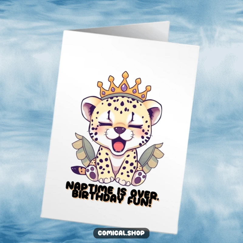 Funny Free Printable Birthday Card: Sleepy cheetah cub wearing a feathered crown, yawning adorably, wishing happy birthday.