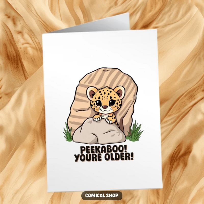 Funny Free Printable Birthday Card featuring a cute cheetah cub playfully peeking from behind a striped rock, filled with birthday cheer.