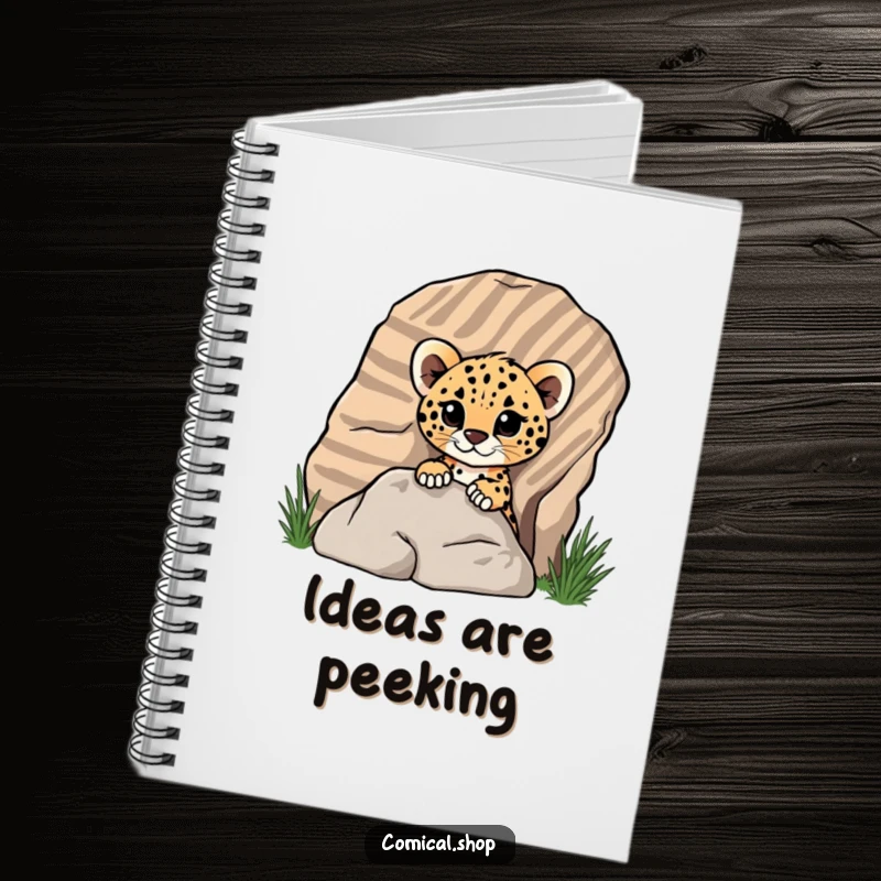 Funny cheetah cub peeking from behind a rock on a notebook cover, showing playful curiosity for screen readers.