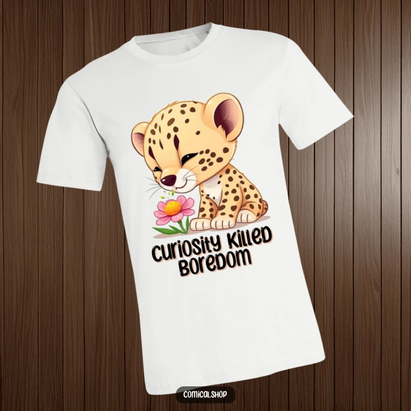Funny cheetah cub t-shirt depicting a cute cub curiously sniffing a vibrant flower, embodying wonder and nature.