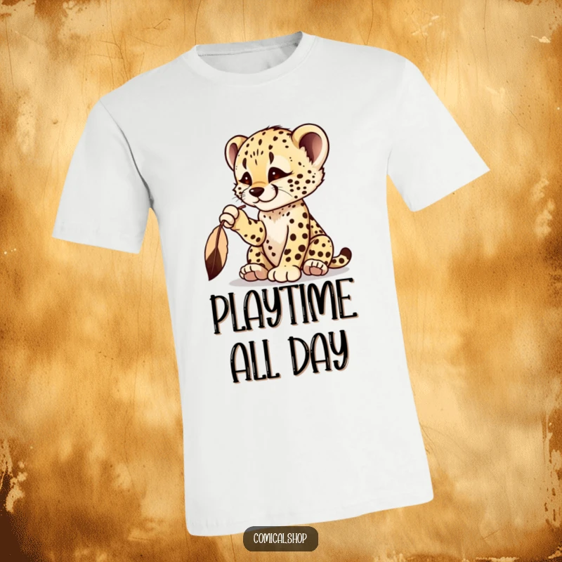 Funny cheetah cub t-shirt with a playful cub batting at a dangling feather, showing intense focus.