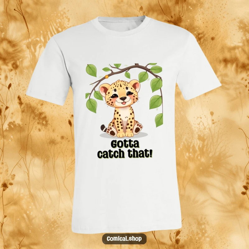 Funny cheetah cub t-shirt featuring a cute cub gleefully batting at a dangling vine, embodying playful jungle exploration and innocence.