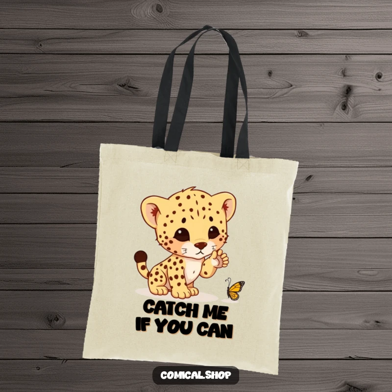 Funny tote bag showcasing a cute cheetah cub's determined, yet comical, attempt to pounce on a tiny butterfly, ready for shopping adventures.