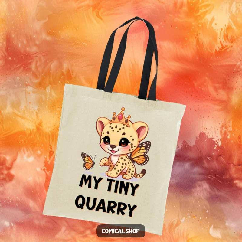 Funny cheetah cub wearing a tiara, playfully racing a butterfly, on a sturdy tote bag, carrying whimsy, a funny gift.