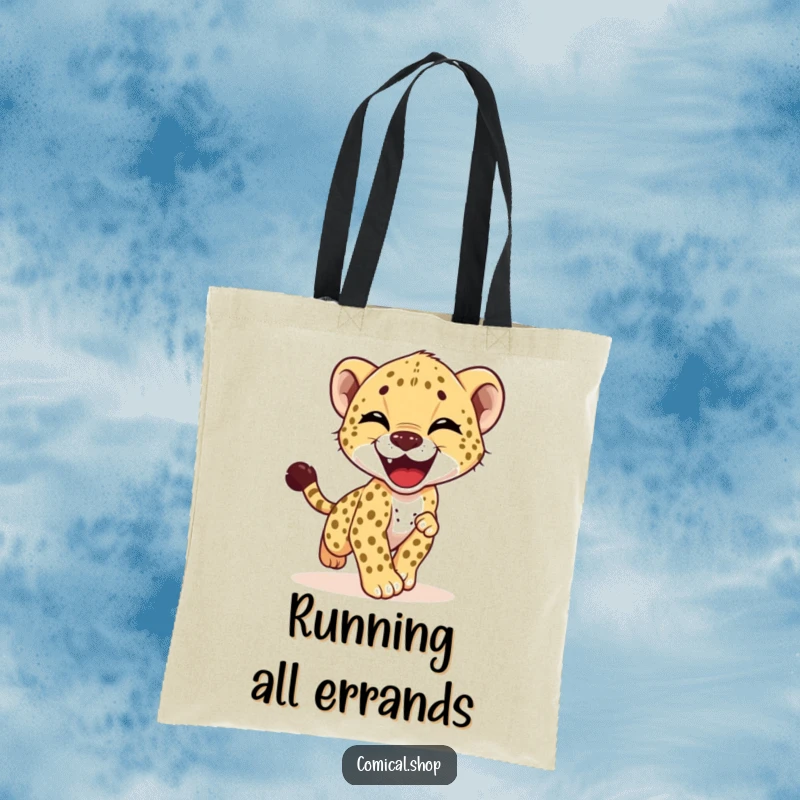 Funny tote bag showcasing a giggling cheetah cub in a hilarious, energetic pursuit of its own tail, radiating happiness.